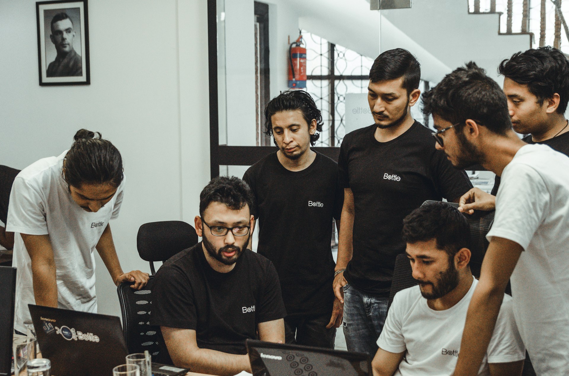 people near a black top computer in a room